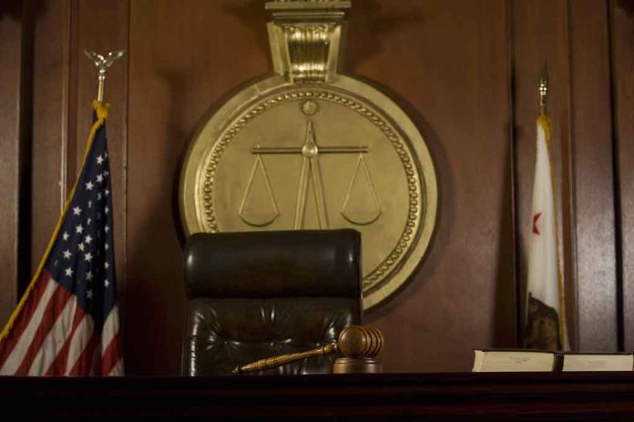 148390607 featured image Judge's chair, gavel, flags, and scales of justice emblem.