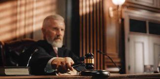 Judge using gavel in courtroom.