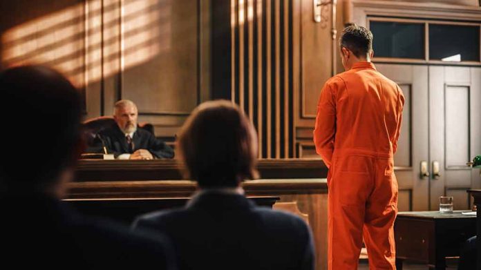 2056433798 featured image Man in orange jumpsuit stands in courtroom facing judge