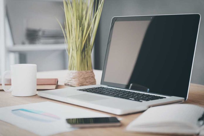 272975225 featured image Laptop on desk with plant and coffee mug.