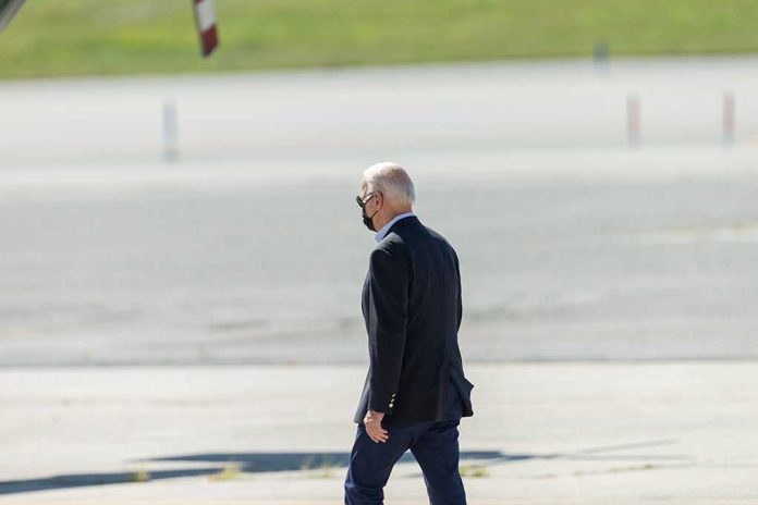 2037826775 featured image Person walking on tarmac wearing a black mask.
