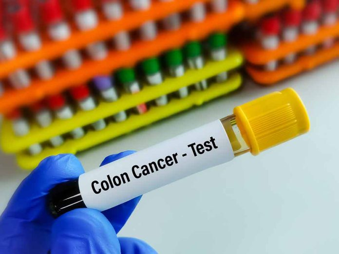 227507861 featured image Gloved hand holding colon cancer test tube