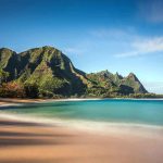 Beach with mountains and clear blue water
