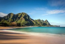 Beach with mountains and clear blue water