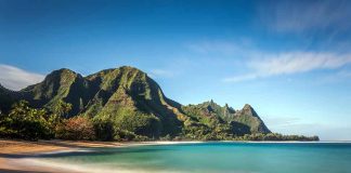 Beach with mountains and clear blue water