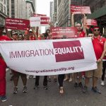 Group holding IMMIGRATION EQUALITY banner at a parade