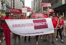 Group holding IMMIGRATION EQUALITY banner at a parade