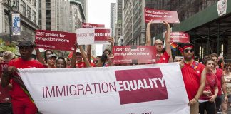 Group holding IMMIGRATION EQUALITY banner at a parade