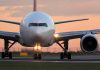 Airplane on runway during sunset lights on