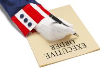 Hand writing executive order on paper