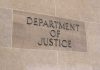 Department of Justice sign on a building.