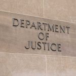 Department of Justice sign on a building.