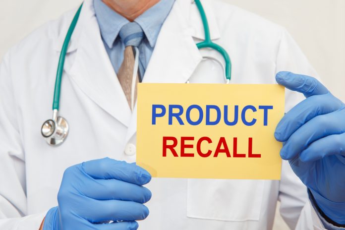 shutterstock_1849024102.jpg featured image Doctor holding a product recall sign in gloves