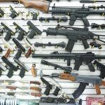 Wall display of various firearms in a store