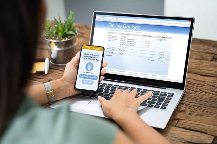 1542438851 featured image Person using phone and laptop for online banking