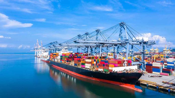 1570847962 featured image Container ship docked at a busy industrial port