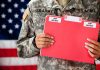Soldier holding red top secret file folder