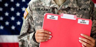 Soldier holding red top secret file folder