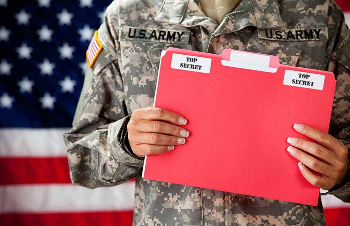 177221078 featured image Soldier holding red top secret file folder
