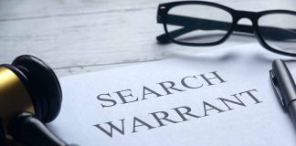 Search warrant document with gavel and glasses