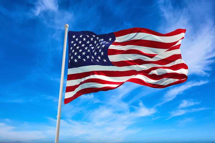 1889979958 featured image American flag waving against a blue sky