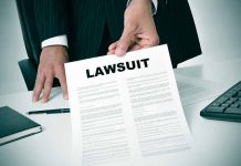 Person holding a document titled Lawsuit