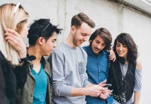 Group of friends looking at a smartphone