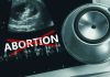 Ultrasound stethoscope and ABORTION crossed out in red