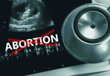 Ultrasound stethoscope and ABORTION crossed out in red