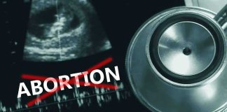 Ultrasound stethoscope and ABORTION crossed out in red