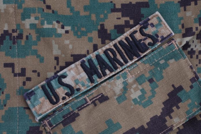 2184490991 featured image US Marines patch on camouflage uniform fabric