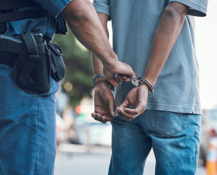2337392319 featured image Police officer handcuffing a person on the street