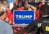 Person holding Trump Make America Great Again sign