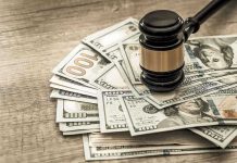 Gavel on a pile of hundred-dollar bills
