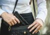 Person placing gun into a handbag