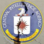 Cracked CIA logo on weathered wall