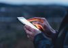 Person using a smartphone at dusk