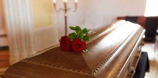 Wooden casket with red roses on top