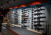 Wall display of various rifles in a gun store