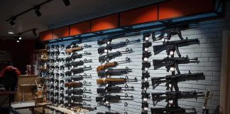 Wall display of various rifles in a gun store