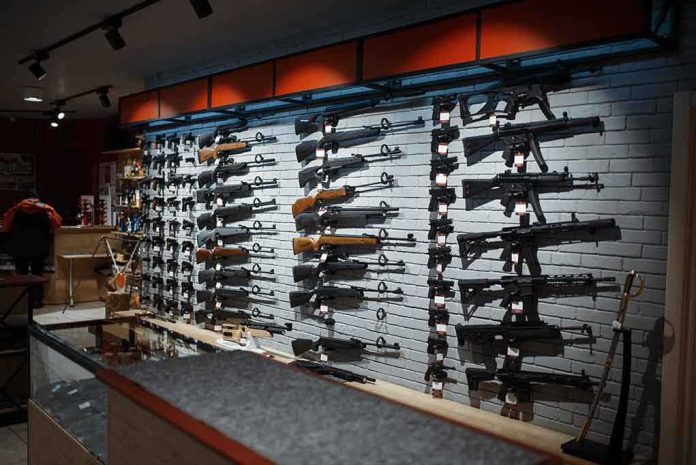 Wall-mounted guns displayed in a store. featured image Wall display of various rifles in a gun store