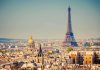 A panoramic view of Paris featuring the Eiffel Tower and a golden dome