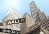 Street signs for Wall Street and Broad Street with skyscrapers in the background