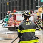 FDNY firefighter at scene with fire truck present