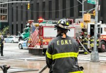 FDNY firefighter at scene with fire truck present