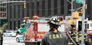 FDNY firefighter at scene with fire truck present