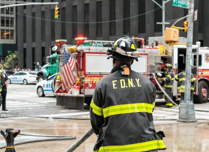 shutterstock_2289473207.jpg featured image FDNY firefighter at scene with fire truck present