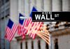 Wall Street sign with American flags in the background