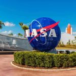 NASA logo sculpture with spaceship and palm trees.