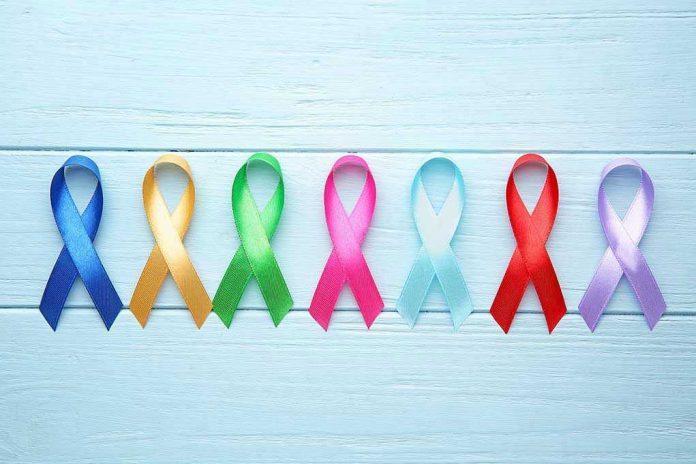 1564226551 Colorful awareness ribbons on light wooden background
